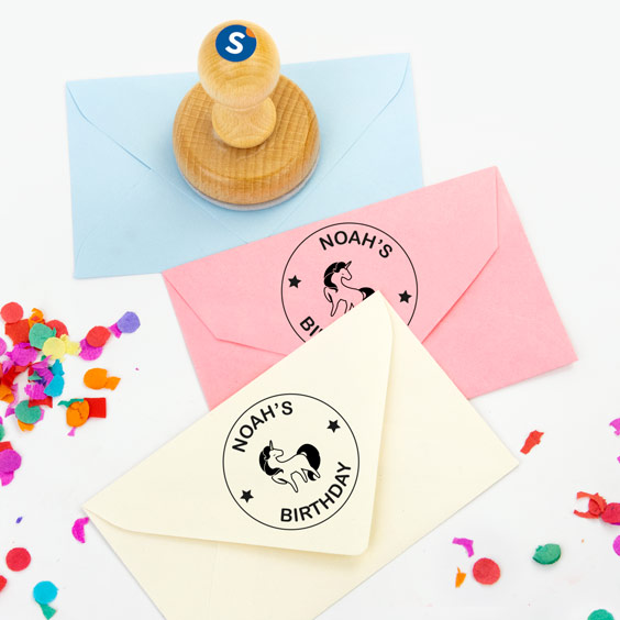 Sobres de colores marcados con sellos redondos personalizados de madera